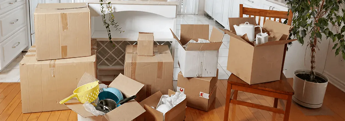 Packed moving boxes and household items in a kitchen before move-out or move-in cleaning, Mobile, AL.